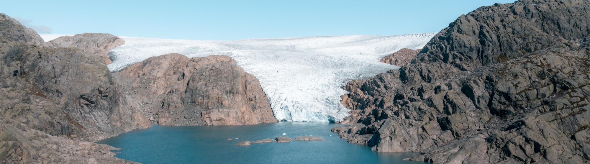 A slow-moving mass of ice formed from compacted layers of snow