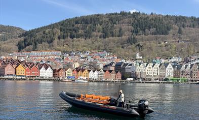 Rib boat with Bryggen in Bergen in the background