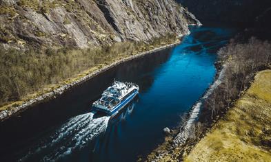 The fjord cruise passes through the narrow Mostraumen 