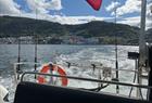 The view from the back of the boat as the boat leaves Bergen