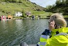 A view of small farms along the way on a fjord cruise in Rib boat on the Hardangerfjord